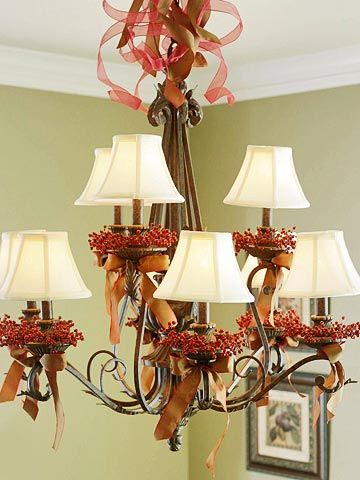 Give a dining room chandelier a Thanksgiving makeover with red berry candle rings and copper satin bows. Sheer and satin ribbon curl into a froth of holiday cheer above the decorated arms. Replace the copper ribbon with ivory for Christmas. Fall Chandelier, Christmas Chandeliers, Christmas Chandelier, Chandelier Decorations, Chandelier Art, Harvest Party, Diy Thanksgiving, Chandelier Decor, Fall Arrangements