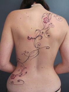 Back Beautiful Vine Tattoo, Vine Tattoos For Women On Back, Pink Spider Lily Tattoo, Flower Vine Back Tattoo, Bingata Tattoo, Lower Back Tattoos Flower, Big Flower Back Tattoo, Whimsical Spine Tattoo, Diagonal Back Tattoo