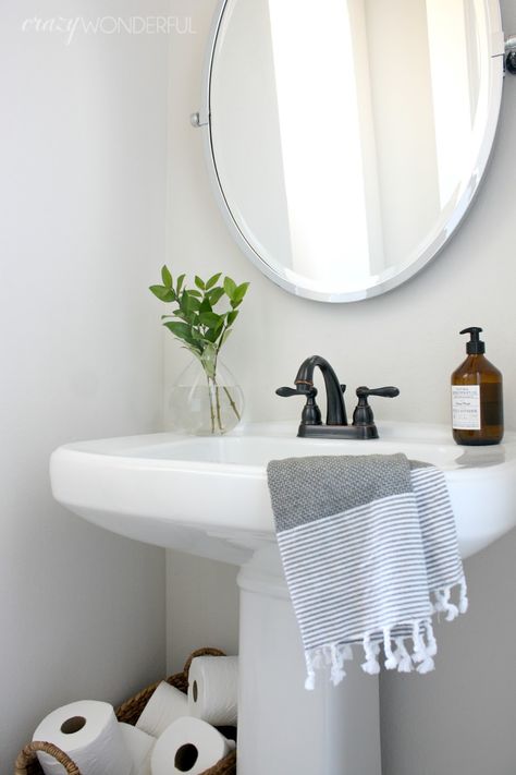 I guess the fancy term is powder room, but we just call it the hall bathroom.  I’ve not purposely been holding this bathroom from you guys, it’s just hard to photograph due to it’s tiny size.  I posted a photo of it on my Instagram over the holidays and afterwards I figured I might as ... Read More about our powder room Powder Room Pedestal Sink, Bathroom Lighting Over Mirror, Tiny Powder Rooms, Pedestal Sink Bathroom, Modern Powder Rooms, Sink Decor, Powder Room Decor, Bamboo Bathroom, Powder Room Design