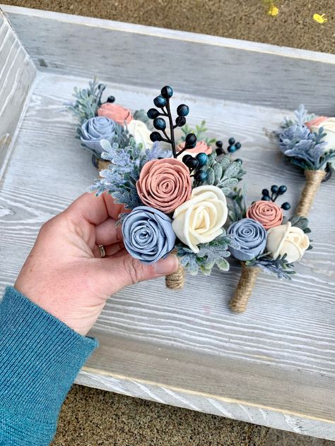 ---Wood Flower Boutonniere --- These boutonnieres will coordinate nicely with any wood flower bouquet! Three mini roses are included. The curled rose will be in ivory, and you can choose the colors of the other two roses. Flowers are handmade, and each has unique coloring from the wood grain. Flowers have beautiful and unique imperfections, as real flowers do, giving your piece an elegant rustic look. The greenery includes navy berries, boxwood and dusty miller. I use strong magnets for boutonni Dusty Rose And Dusty Blue Wedding Flowers, Dusty Blue And Pink Boutonniere, Dusty Blue And Dusty Rose Wedding, Dusty Rose And Dusty Blue Wedding, Dusty Blue And Pink Wedding Theme, Bridesmaid Bouquet Eucalyptus, Bridesmaid Flower Bouquets, French Themed Wedding, Bouquet Eucalyptus