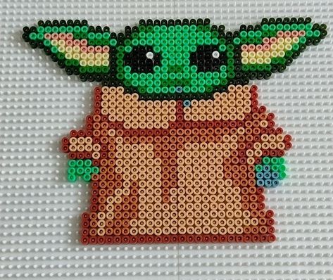 Star wars the Mandalorian, Grogu eating a cookie. Hama Beads. Grogu Cross Stitch Pattern, Grogu Perler Bead Pattern, Grogu Eating, Star Wars Blanket, The Mandalorian Grogu, Mandalorian Grogu, Easy Perler Beads Ideas, Fuse Bead Patterns, Perler Art