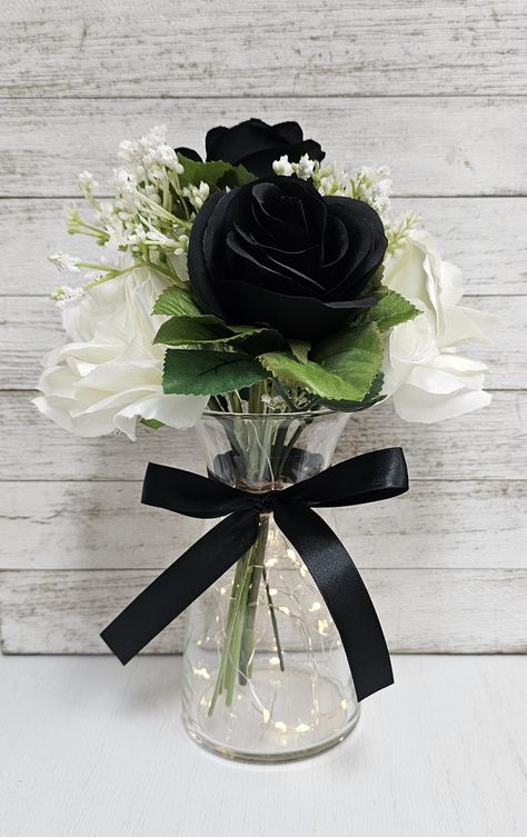 These beautiful centerpieces are perfect for your next event and include a glass vase with a set of warm white LED fairy lights, one black and white silk rose arrangement, and a black ribbon bow.  They are very popular for weddings, baby showers, parties, corporate events, holiday events, and any other event that requires table centerpieces. They also look great in any room of your house or office. To see other lighted jar options and all of my other listings, please view my shop: https://www.et