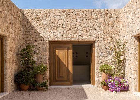 Can Brut by Framework Studio | Global Interiors | est living Organic Interior, Stone Building, Custom Kitchens Design, Casa Exterior, Traditional Building, Wood Panel Walls, Majorca, Outdoor Dining Area, Garden Wall