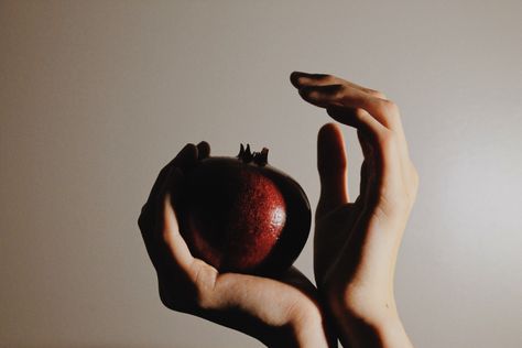 Hands holding a pomegranate Hand Holding Pomegranate, Hand Holding Fruit, Modern Persephone, Poem Inspo, Persephone Aesthetic, Holding Fruit, Fruit Shoot, Aesthetic Writing, Fairytale Aesthetic