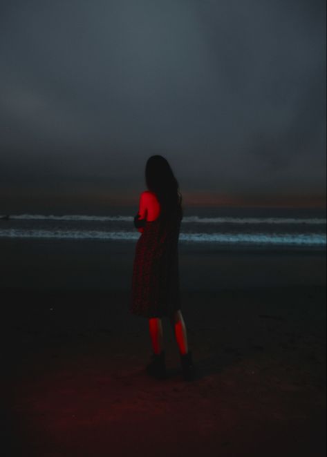 Girl standing at the beach in Los Angeles. Red lights, crashing dark waves and a red neon light shines. Night Flash Beach Photos, Night Beach Shoot, Late Night Beach Photoshoot, Night Beach Aesthetic, Late Night Beach Pictures, Night Beach Editorial, Night Ocean, Photography Night, Night Time Photography