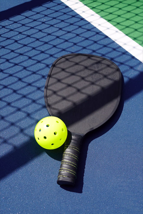 Learn all about the newly popular sport pickleball, including how to play pickleball, why it's called pickleball, and the health benefits of pickleball. Wiffle Ball, Ping Pong Paddles, Different Sports, Popular Sports, Racquet Sports, Pickleball Paddles, Paddles, Ping Pong, Pickleball