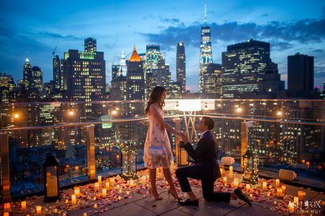 Glowing candles and flower petals on a rooftop in front of the New York City skyline Proposal New York, Skyline Proposal, Candlelit Proposal, Ash Fox, New York Proposal, Destination Proposal, Proposal Setup, Rooftop Proposal, Wedding Dinner Decor