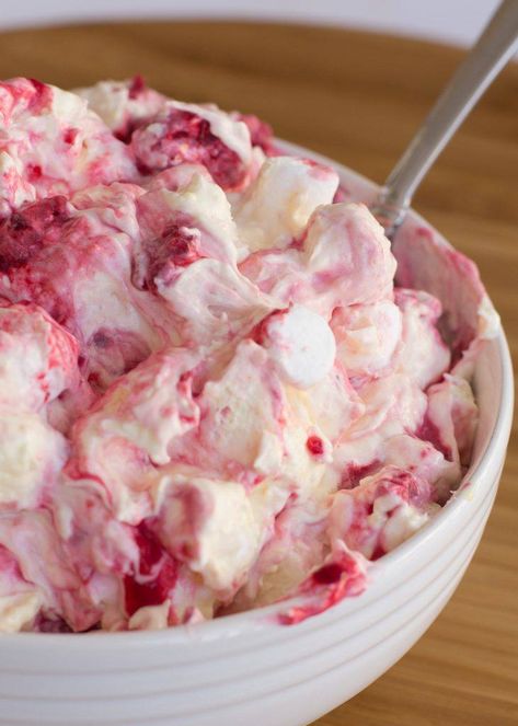 This raspberry marshmallow fluff salad is so light and fluffy. A mixture of raspberries, whip, pudding, yogurt and marshmallows make this dessert recipe. Marshmallow Fluff Salad, Creamy Salads, Fluff Recipes, Raspberry Recipes Dessert, Marshmallow Fluff Recipes, Fluff Salad Recipes, Raspberry Salad, Jello Salads, Whipped Yogurt