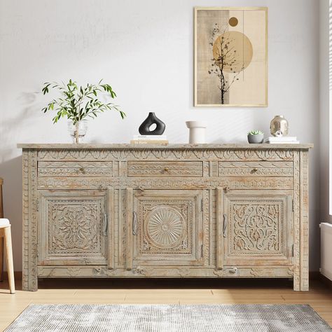 In the fusion of natural wood grains, distressed finish, hand carving details, and meticulously chosen other hues, Our Mendocino Distressed Hand Carved Mid Century Sideboard with 3 Drawers has a captivating and distinct aesthetic emerges. That is the magic of this mid-century sideboard – a showstopper that effortlessly combines nature’s allure with a touch of artistry, making it a true standout in any space. This multifunctional intricated hand-carved sideboard is a storage powerhouse with a sleek generous countertop surface, three cleverly dual-tiered cabinets, and three inline petite drawers. It is like a secret agent for your dishes and linens, complete with sturdy intricately hand-carved doors sporting sleek metal hardware equipped with wooden latches and drawers donning iron knobs for Carved Sideboard, Living And Kitchen, Painted Sideboard, Buffets & Sideboards, Countertop Surfaces, Mid Century Sideboard, Antique Sideboard, Solid Wood Sideboard, Cabinet Style