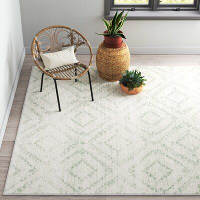 Add geometric flair to your living room, bedroom, or den with this boho-inspired area rug. Power-loomed using a polypropylene pile, this rug has a latex backing that prevents slipping without requiring a rug pad. The pattern features a light green design of geometric diamonds with a distressed look to add an antique quality. The all-over ivory background brightens and elevates your space. We love that this rug has a low 0.43'' pile height, great for withstanding heavy foot traffic in busy areas. Green Rug For Nursery, Light Green Rug Living Room, Nursery Rugs Sage Green, Area Rug For Green Couch, Neutral Green Rugs, White Rug With Green Accents, Sage Rug Nursery, Sage Nursery Rug, Green And White Rugs