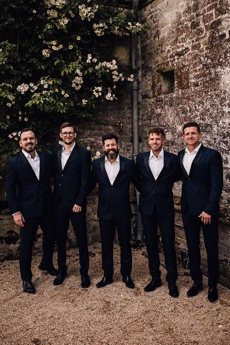 Groom with groomsmen standing together in matching suits without their bow ties Groomsman Speech, Groom With Groomsmen, Matching Suits, Wedding Party Groomsmen, Silent Disco, Grooms Party, Mens Wedding Attire, Groomsmen Bowtie, Groomsmen Outfits