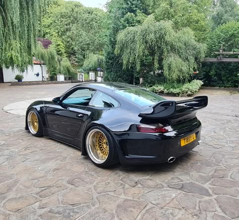 Wide black Porsche 996. Full tuning. Full wide body conversion. Wide gold wheels, big rear wing. Porsche 996 Custom, Widebody Porsche, Car Motivation, Porsche 996 Turbo, 996 Porsche, Porsche Boxster 986, Custom Porsche, Rich Cars, Rauh Welt