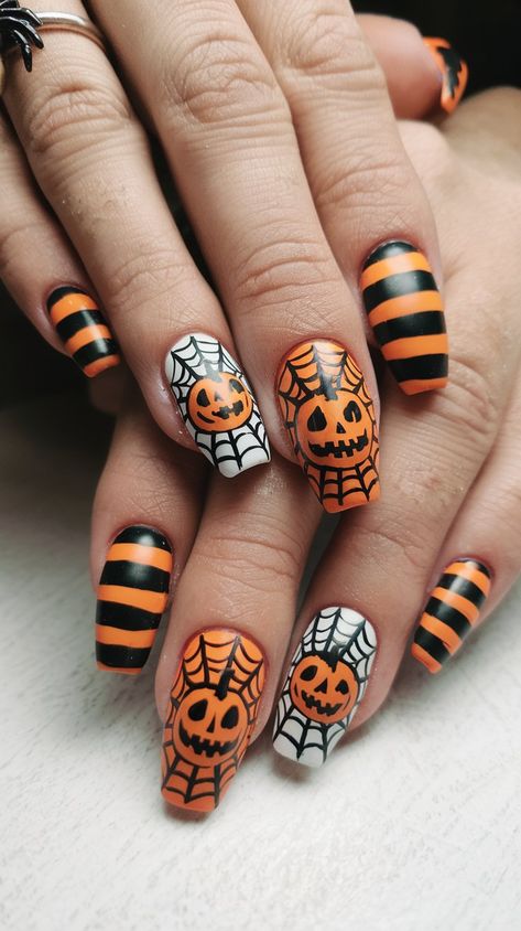 Get ready for a hauntingly chic look with these matte black nails adorned with vibrant orange stripes. The standout feature? Tiny white skulls scattered on select nails. This design combines spookiness with style, making it ideal for Halloween celebrations or any frightful occasion! #acrylicnails #nailsdesign #halloweennails #septembernails #octobernails #nailsdesign #nailsinspo #fallnails #nailsideas Orange Stripe Nails, Halloween Town Nails, Orange And Black Halloween Nail Designs, White Striped Nails, Pastel Nail Art, Matte Black Nails, September Nails, Nail Color Trends, Festive Nail Art