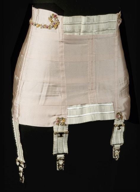 Woman's Corset  Made by Corset H. Co., Worcester, Massachusetts. Sold by Ivy Corset, Worcester, Massachusetts.  Date: c. 1920s Medium: Pink silk grosgrain ribbon, ivory decorative elastic, multicolored silk ribbon floral trim  Accession Number: 1973-112-17 1920s Corset, Antique Corset, Ribbon Clothes, Worcester Massachusetts, Corset Skirt, Retro Lingerie, Corset Fashion, Girdles, Vintage Corset