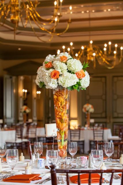 towering orange  white wedding centerpiece of hydrangeas  roses + submerged orchids / Koru Wedding Style: {Orange  White Florida Wedding} Soliane  Mackendy Orange White Color Palette, Orange Quince, Orange Quinceanera, Orange Wedding Centerpieces, Orange Wedding Decorations, Burgundy Wedding Centerpieces, Orange Centerpieces, Hanging Amaranthus, White Wedding Centerpieces