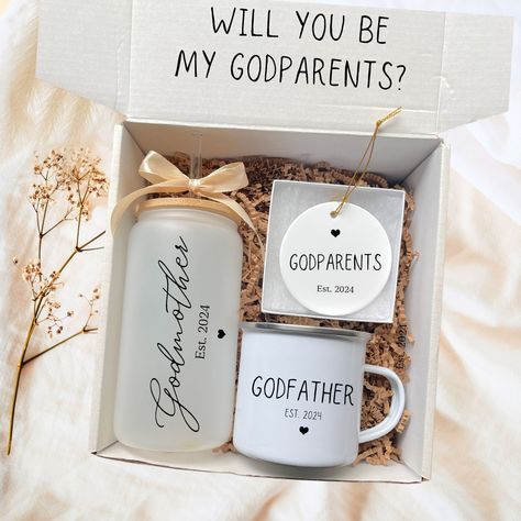 Are you looking for a unique and thoughtful way to ask " Will you be my Godparents? Imagine the joy of discovering not just a gift, but an invitation to be part of your child's life journey. Unboxing this Godparent Proposal box isn't just about the treasures inside; it's about unlocking a special bond that lasts a lifetime.   Honor your godparents with this heartfelt gift set with a personalized Godmother tumbler, mug, and ceramic ornament beautifully packaged with care and love. GODPARENT PROPO How To Ask To Be Godparents Good Ideas, Ask Godparents Ideas, Ideas On How To Ask Godparents, Will You Be My Godparents, Ways To Ask Someone To Be A Godparent, God Parents Proposal Ideas, Cute Ways To Ask Godparents, Gift Box For Godparents, How To Ask Someone To Be A Godparent