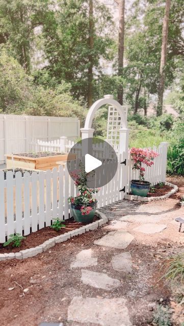 Scarlett Knuth on Instagram: "Introducing White Florida Farmhouse: The Garden. 🪴⛲️👩‍🌾💐🪻🌻🌸  When we first moved in this home 3 years ago, the backyard was all ferns. As in ferns for miles. We still have lots of them. 🤦🏻‍♀️ But for this corner of the yard, I had homesteading visions.   First, the chicken coop was the priority when we moved in. 🐓 Then, earlier this year, I hired @man.in.overalls to help me learn to grow our own groceries. He and his amazing team started with clearing the space, finding a fence partner to build out my dream white scalloped picket fence with an arch, then installing four raised beds to do square footage gardening, and created an auto irrigation system to help me keep everything alive.   Additionally, it was a lot of sweat with my family and friends he Man In Overalls, White Picket Fence Garden, Florida Farmhouse, Picket Fence Garden, White Picket Fence, Backyard Farming, Garden Pathway, Memorial Garden, Backyard Projects