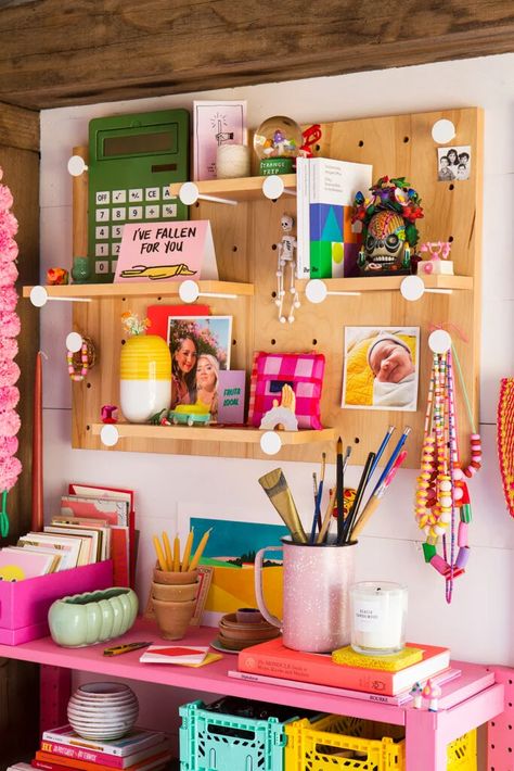 Bubblegum Pink Paint Turned This Backyard Studio Into a Crafting Wonderland | domino Snack Bin, Striped Accent Wall, Photo Booth Picture Frames, Backyard Crafts, Desk Nook, Pegboard Display, Modern Wrapping Paper, Renegade Craft Fair, Backyard Studio