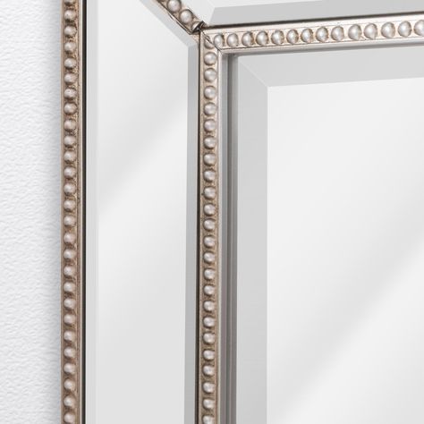 "Buy Head West Beaded Champagne Silver Framed Wall Vanity Mirror at Michaels. com. Victorian goes modern, and classic never goes out of style with this beautifully hand-crafted beveled mirror frame. Victorian goes modern, and classic never goes out of style with this beautifully hand-crafted beveled mirror frame. Four ornate beveled mirrors, bordered by delicate champagne-colored beading, frame a large rectangular mirror, creating a piece that injects an elegant flair into any room. Its versatil Wall Vanity Mirror, Framed Vanity Mirror, Beaded Mirror, Wall Vanity, Mirror Panels, Mirror Plates, Cool Mirrors, Beautiful Mirrors, Rectangular Mirror