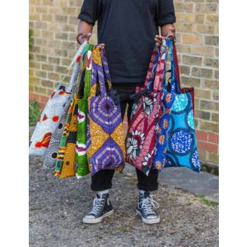 These African wax print tote bags are beautifully made, with French seams. More durable and easy to fold away. These statement totes look amazing and are so practical. Double handled giving you versatility. Glorious Batik patterns, and are handmade by Lolly & Kiks, in her London studio. The tote bags come in various colours and patterns. Product information: Material: 100% cotton. Measurements: Bag 45 cm x 37 cm. Long handles 63 cm. Total bag hanging length from the shoulder is approximately 75 Ankara Bags, Denim Bag Patterns, African Gifts, Canvas Bag Design, African Bag, African Accessories, African Inspired Clothing, Boho Bags, African Wax Print