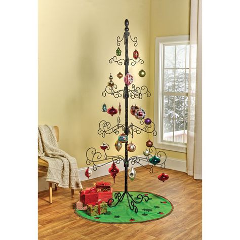 The best way to display your most treasured ornaments, and those too small or delicate to risk on a regular tree. Five tiers of handcrafted, scroll-shaped wrought iron branches give each ornament room to shine without crowding. Leave the tree up year-round to decorate for all holidays, or hang family photos or memorabilia. Black finish, carved wood finial. 35" diameter, 83" high. Easy assembly, easy disassembly for storage. Ornament Display Tree, Metal Ornament Tree, Christmas Ornament Display, Wrought Iron Christmas Tree, Ornament Tree Display, Display Tree, Alternative Christmas, Alternative Christmas Tree, Ornament Display