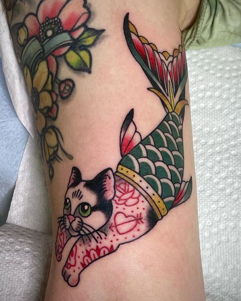 Cat | cat tattoo | tattoo aesthetic | traditional tattoo | green | catfish | fall outfits | october | gomiminal | zara | pinterestinspo | women | womentattoos | Back Of Arm Tattoo Neotraditional, Catfish Tattoo For Women, Traditional Style Cat Tattoo, Purrmaid Tattoo, Tradional Tattoo Women, Mercat Tattoo, Cat Mermaid Tattoo, Neo Traditional Cat Tattoo, Cat Traditional Tattoo