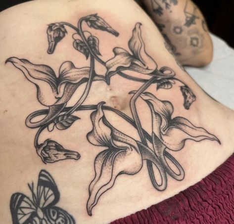 Stomach Tatoos Woman, Stomach Tattoo Flowers, Stomach Tattoos Traditional, Side Torso Flower Tattoo, Whimsical Stomach Tattoo, Pink Floyd Flower Tattoo, Gothic Plant Tattoo, Plant Stomach Tattoo, Moth Stomach Tattoos Women