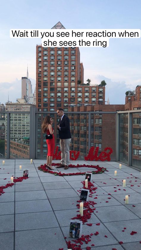 Stunning marriage proposal on a private rooftop in New York
 • Private rooftop 
 • Paparazzi style photographer 
 • Candle and rose petals
 • Marry me sign
 • Family
 • Engagement ring Family Engagement Ring, Wedding Proposal Videos, Marry Me Sign, Surprise Proposal Pictures, Cute Proposal Ideas, Private Rooftop, Proposal Videos, Unique Proposals, Proposal Pictures