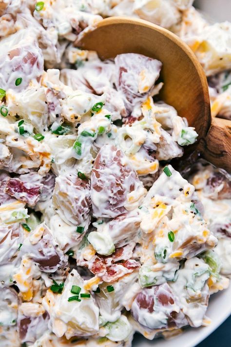 This Ranch Potato Salad is loaded with tender red potatoes, sharp Cheddar cheese, crispy bacon, and fresh green onions. This salad has a quick two-ingredient ranch and sour cream dressing. Recipe via chelseasmessyapron #bacon #recipe #cheddarbacon #easybacon #easy #creamy #ranch #potato #salad Ranch Dressing Potatoes, Sour Cream Potato Salad, Red Potato Salad Recipe, Loaded Potato Salad, Sour Cream Potatoes, Ranch Potato Salad, Roasted Potato Salads, Bacon Ranch Potatoes, Red Potato Salad