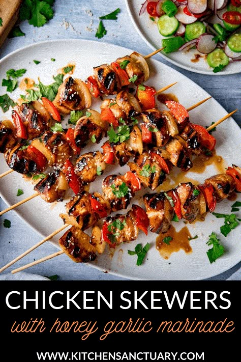 Honey Garlic Chicken Skewers - Tender pieces of marinated chicken cooked on a BBQ or griddle for a sweet and smoky flavour. The best chicken kebabs made at home! #chickenkebab #chickenskewers