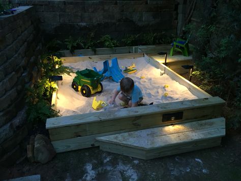 Custom sandbox, with storage and mini-deck, LED lighting. Requires 44 50lb bags of sand. Sandbox portion is 6' x 8'... Built in 2 days on the weekend. Diy Sand Box With Lid, Built In Sandbox Sand Pit, Outdoor Sandbox Ideas Easy Diy, In Ground Sandbox Ideas, Sand Box With Lid, Big Sandbox Ideas, Sandbox Toy Storage Ideas, Large Sandbox Ideas, Outdoor Sandbox Ideas