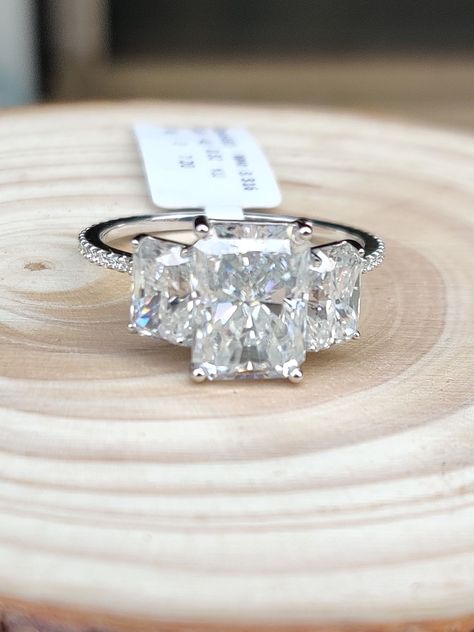 We love how fashion-forward and modern this entirely radiant Camilla Ring looks. ---------------------------- - 4.4 carat center (1.42 ratio) - 11x7.75mm crushed ice hybrid radiant, modern white moissanite in a two-tone 14k White and Yellow gold setting - Two 1.2 carat (7x5mm) flanking radiant side stones - Triple micropave band Jewelry Information Brand, Seller, or Collection Name: Charon jewels Material: 14k White and Yellow gold , metal Center Stone Type: Moissanite Setting: Prong-Setting Sto 3.7 Carat Engagement Ring, Radiant Cut 3 Stone Engagement Ring, Three Stone Radiant Cut Engagement Ring, 3 Stone Radiant Engagement Ring, 3 Stone Engagement Rings With Band, Center Stone Engagement Ring, Yellow Gold Moissanite Ring, Big Wedding Rings, Gold Moissanite Ring