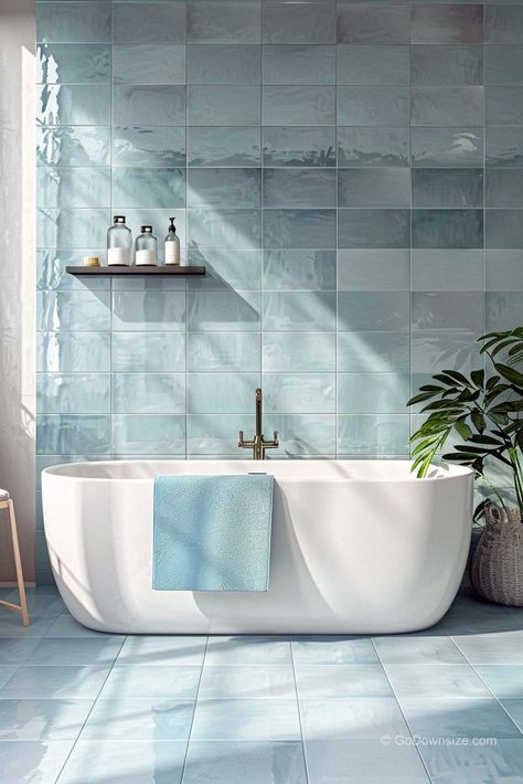 In this bathroom, the pale blue tiles bring a calming vibe, like a day by the sea. Bathroom Ideas Light Blue, Bathroom Blue Floor, Blue Bathroom Ideas Decoration, Blue Tiles Bathroom, Sea Bathroom Ideas, Baby Blue Bathroom, Bathroom Tiles Blue, Light Blue Bathroom Ideas, Pale Blue Bathroom