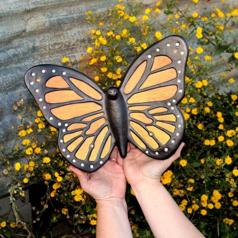 This stylish and graceful wall-mounted urn has a simple form, yet sophisticated beauty. Uniquely styled with monarch markings and a black metal-like finish, it is ideal for the butterfly collector, gentle nature lover, and free spirited soul.Free Hand Engraved Personalization Included• Wall-Mounted Unit • 14”w x 10”h x 2.5”d • 115 cubic inch capacity • 3 lbs. approx. weight • Free Name/Dates Engraving Included, placed along sidewalls  Engraving Details: 50 characters max- please select f... Carving Art, Clay Wall, Memorial Urns, Human Ashes, Simplest Form, Cremation Urns, Monarch Butterfly, Engraved Items, Free Spirited