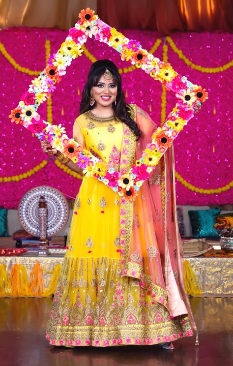 #PunjabiJago outfit, #yellowdress for mehndi #heavyembroidery gown for #mehndi #Punjabiwedding #yellowlehnga #photobooth frame #lehnga # yellow outfit for Haldi # yellow gown for #sangeet # heavy embroidery #pinkdupatta with yellow gown #yellowgown for #weddingreception #floralframe #mehndiphotobooth Photo Frame For Haldi, Haldi Photo Frame Ideas, Haldi Frame, Photobooth Ideas For Haldi, Haldi Photo Booth Ideas, Ladies Sangeet Decoration, Yellow Mehndi Outfit, Haldi Photo Booth, Gown For Sangeet