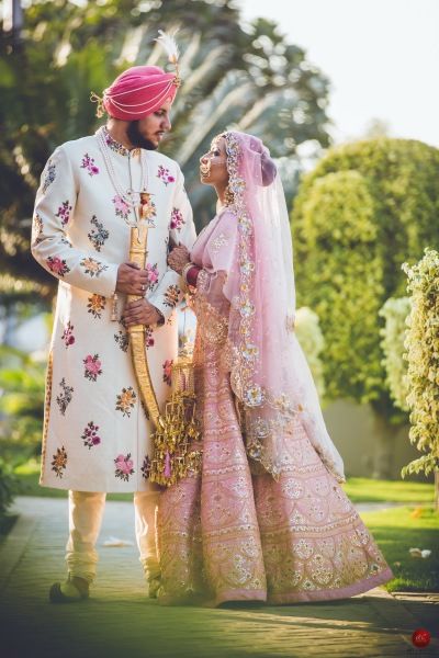 Candid Couple Shot - Bride in a Pink Heavy Lehenga with the Groom in   a White and Floral Sherwani | WedMeGood Shot by: Artcapture Productions #wedmegood #indianbride #indianwedding #bridal #coupleshot #candid #pink #gold #sikhwedding #sikhweddingcouple Pastel Outfits, Multicolor Wedding, Light Pink Wedding, Punjabi Bride, Indian Wedding Planning, Indian Groom, Punjabi Wedding, Sikh Wedding, Bridal Dress Design