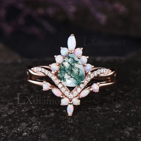 Item description ✦ Handmade, high-quality item! ✦ Material: Solid 10k/14K/18K GOLD (can be made in white/rose/yellow gold) Engagement ring ✦ Center stone: Natural Green Moss Agate. ✦ Size/Weight: 6x8mm Pear Cut ✦ Side stones: Marquise Cut/Round Cut Lab Opal and Moissanites Wedding band ✦ Gemstones: Marquise Cut and Round Cut Lab Opal Any ring size can be made,if the ring size is not in the option list ,contact me. As it is handmade,it needs 2-4 weeks to finish and then be shipped by usps or DHL. Return policy: We offer 30 days return policy. For any reason, if you are not completely satisfied with your order, you may return it for a refund.  Buyer is responsible for the handcraft fee (15%-30% of the total price) and the return shipping cost. Moss Agate Engagement Ring Teardrop, Vintage Opal Engagement Rings, Moss Agate And Opal Engagement Ring, Moss Agate Ring Set, Moss Agate Wedding Ring Set, Agate Wedding Ring, Art Deco Rose, Wedding Ring Art, Wedding Rings Art