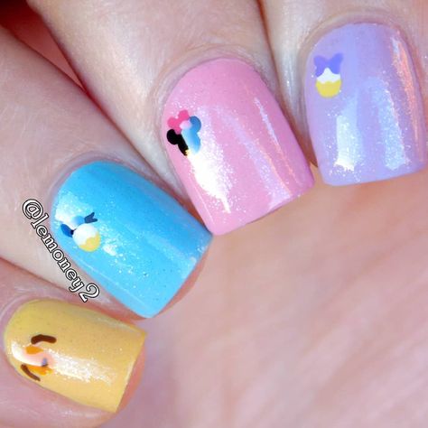 Inspired by @penneys_perfect_nails for this tiny disney design! Yellow: Sinful Colors "Yolo Yellow" Blue: Sinful Colors "Wonder Mint" Pink: Sinful Colors "24/7" Purple: Sally Hansen "Lacey Lilac" All colors were topped with Hello Kitty "Frosted Cupcake" for some sparkle and then Seche Vite for the top coat Purple Disney Nail Designs, Disneyland Nail Art, Low Key Disney Nails, Disney Nail Designs Acrylic Disneyland, Nails Design Yellow, Purple Disney Nails Mickey Mouse, Yellow Sparkle, Disney Princess Nails, Disneyland Nails