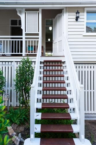 stairs on the front veranda of a Queenslander home Queenslander Architecture, Modern Queenslander, Front Veranda, Queenslander Homes, Queenslander Renovation, Queenslander House, Front Stairs, Timber Stair, Front Verandah