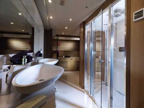 A large shower and twin basin vanity furnishes the sophisticated bathroom. Luxury Yacht Interior Bathroom, Luxury Yacht Bathroom, Yacht Bathroom, Office Bathrooms, Yacht Ideas, Bathroom Architecture, Luxury Yacht Interior, Braids Ideas Cornrows, Simple Bathroom Designs