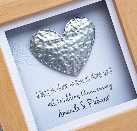 "♥ Look who's back? ♥ Our Lovely and unusual range of frame designed for 10th tin Anniversary. A small frame featuring a flourish border on a white linen card and raised hammered tin heart with a \"What is done in love in done well..\" as a standard wording. All captured in light wood effect frame with real glass front for perfect finish. This heart has an excellent 3D effect in a frame. Personalised with couple's names This frame is great to be free standing in a office or hung on the wall. Fra Tin Anniversary Ideas, Tin Wedding Anniversary Gift, 10year Anniversary Ideas, Flourish Border, Tin Anniversary Gifts, Tin Anniversary, Wedding Anniversary Decorations, Aniversary Gifts, Diy Anniversary Gift