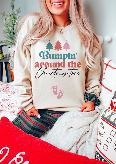 "🎄Celebrate the most wonderful news of the year with our \"Bumpin Around the Christmas Tree\" pregnancy announcement sweatshirt - the coziest and most festive way to share your joyous news this holiday season! Adorned with a heartwarming design, this XMas maternity sweater is not only a perfect gender reveal jumper but also an adorable new mom baby gift. Capture the magic of the season and make your announcement extra special by ordering yours today! 👕 PRODUCT INFO This classic unisex long sleeve tee fits like a well-loved favorite. Casually elegant with an excellent quality print, it is an irreplaceable everyday item for anyone. * Medium-heavy fabric (8.0 oz/yd² (271.25 g/m * Loose fit * Runs true to size * 50% cotton, 50% polyester ✏️ DESIGN Designs are printed onto the shirt using Dir Bumpin Around The Christmas Tree, Christmas Gender Reveal Outfit, Maternity Christmas Sweater, Pregnant Christmas Outfit, Gender Reveal Outfit For Mom, Pregnant Christmas, Baby Announcement Christmas, Im Pregnant, Christmas Gender Reveal