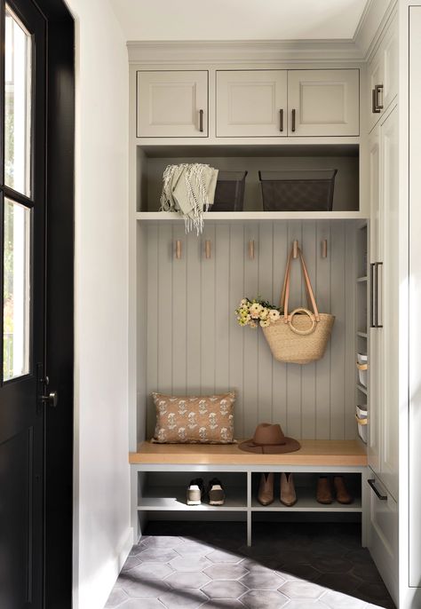 The mudroom was painted with Benjamin Moore’s Half Moon Crest, a sage-gray hue. The floor tiles are Arto, the cabinet hardware is by Top Knobs and the stained-ash hooks were designed by Kates Small Mudroom Built In, Mcgee Mudroom, Small Mudroom Storage, Entry Mudroom Ideas, Gray Beadboard, Kennel Room, Beadboard Trim, Drop Station, Foyer Mudroom