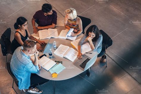 Mixed race students sitting at table with books and laptop studying together. Study Tips For High School, People Studying, Tips For High School, Studying Together, Study Strategies, Technology Photos, Group Study, Business Degree, Student Studying