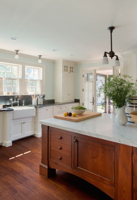 Cottage kitchen with large cherry island topped with a carrara marble illuminated by a bronze two arm pendant light with frosted glass shades. Kitchen Island With Sink, Best Kitchen Cabinets, Farmhouse Kitchen Island, House Of Turquoise, Cherry Cabinets, New Kitchen Cabinets, Kitchen Marble, Black Granite, Trendy Kitchen