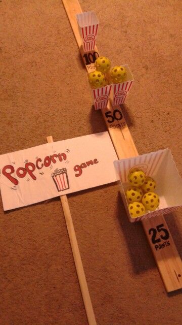 Dollar store popcorn carnival game i made for National Night Out. Popcorn buckets, small waffle balls painted yellow and wood board and marker Scout Carnival Games, Hollywood Themed Games, National Night Out Activities, Popcorn Kickoff Cub Scouts, Popcorn Games For Kids, Cub Scout Popcorn Kickoff Ideas, National Night Out, National Night Out Ideas, Hollywood Party Games