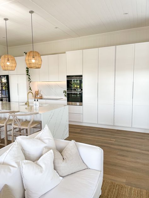 White coastal kitchen with rattan pendants and timber floors. Marble look stone bench top and white sofa couch Reno Diary, Coastal Kitchen Design, Butler’s Pantry, Butlers Pantry, Coastal Kitchen, Home Styling, Butler's Pantry, Food Pantry, Kitchen Inspo