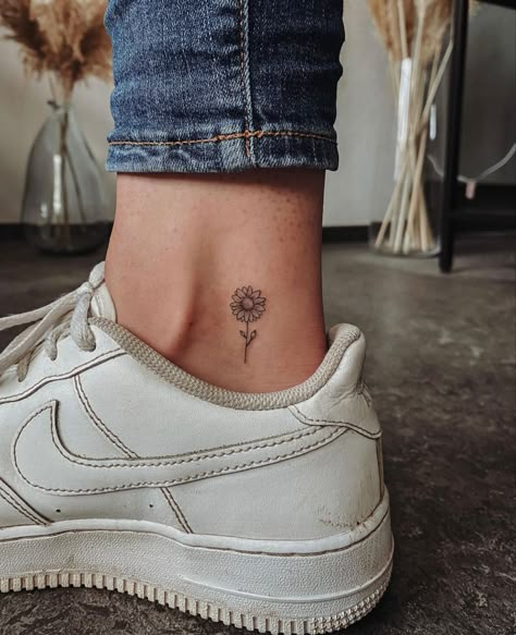 Small Ankle Tattoos For Women Flowers, Small Sunflower Tattoo On Ankle, Sunflower Tattoo Back Of Leg, Small Daisy Tattoo Ankle, Simple Tattoos Sunflower, Ankle Sunflower Tattoo, Upper Ankle Tattoo, Small Sunflower Tattoos For Women, Small Daisy Tattoos For Women