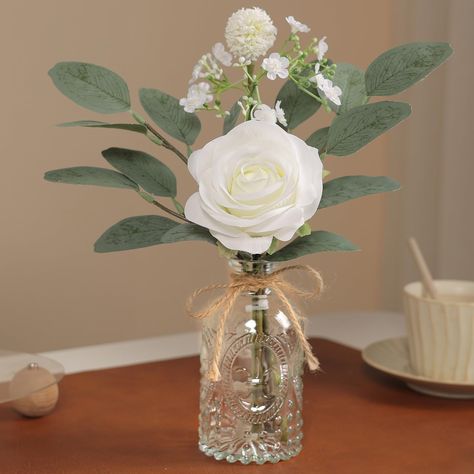 PRICES MAY VARY. [Artificial flowers with Vase include] : 1 white rose, 1 white flower ball, artificial baby breath flowers, artificial eucalyptus, and a glass Bud Vase with twine. The perfect combination of small bouquets and vases, rustic style is perfect for farmhouse decor, desk decor, and living room table decor. [Quality materials] : Roses are made of high quality silk, artificial plants are made of high quality plastic, their stems are made of paper wrapped wire, the stems are flexible, y Fake Flower Centerpieces, Living Room Table Decor, Eucalyptus Centerpiece, Plant Centerpieces, Room Table Decor, Fake Flower Bouquet, Feuille Eucalyptus, Stil Rustic, Table Centerpiece Decorations