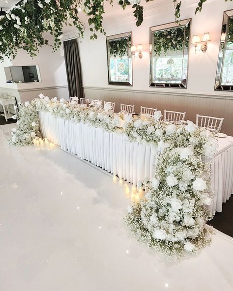 So many little dazzling crystals hanging down from our low and high floral table decor 🤍 For our amazing couple Joanne and Edwin! #weddingflowersdecoration #flowersforwedding #luxuryweddingflowers #weddingfloristry #tablecentrepiece #eventflorals #weddingflorists #flowercenterpiece #flowerdecorations #flowersdecoration #weddingceremonydecor #weddingflowerideas #weddingspecialist #eventstylists #floraldesigners #weddingflowerinspiration #flowersarrangement #luxuryfl Venue • @poetslane Flor... Wedding Main Table Decor, Wedding Reception Entrance Decorations, Head Table Flowers, Bride Table, Main Table Wedding, Head Table Wedding Decorations, Floral Table Decor, Small Wedding Decor, Brides Table